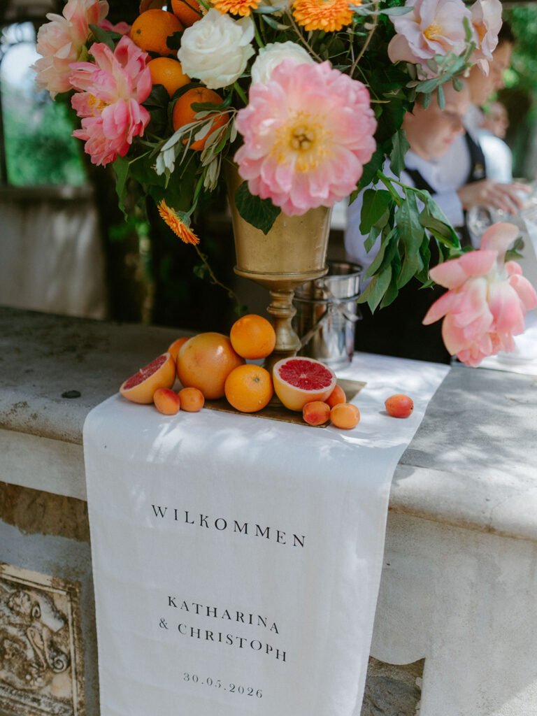 Wedding welcome sign with colourful floral arrangement for Katharina and Christoph