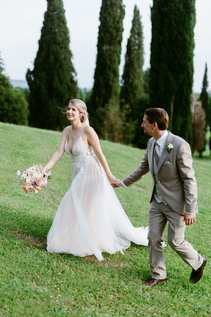 Bride and groom walking through the gardens of Castello di Spessa