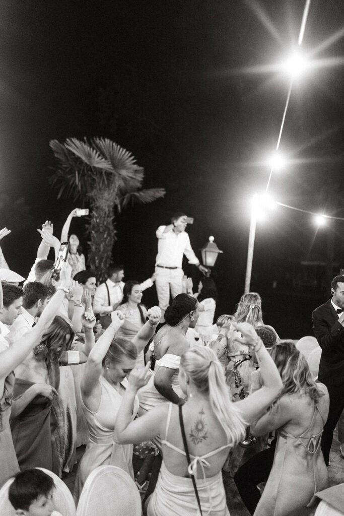 Wedding guests dancing and celebrating during the evening party