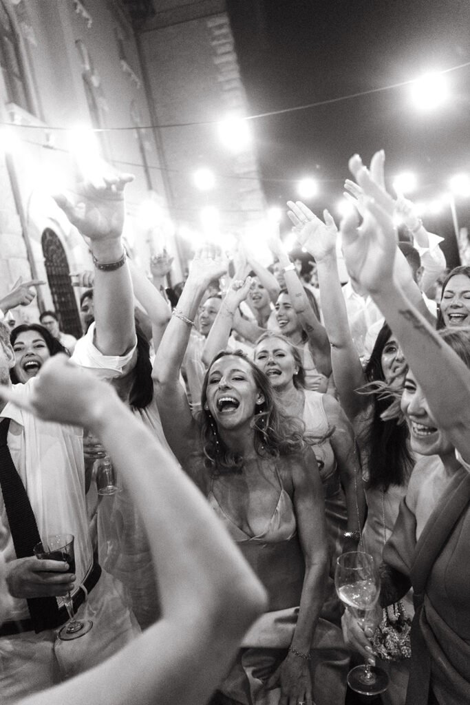Wedding guests dancing and celebrating during the evening party